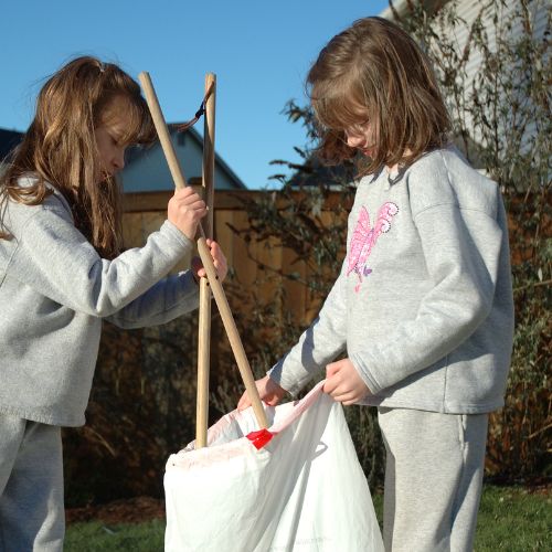 Two sisters helping clean up outdoors